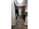 Galley kitchen featuring black appliances, wood-look flooring, and ample cabinet space at 445 Fountainhead Cir # 262, Kissimmee, FL 34741
