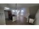 Living room with an open concept kitchen, staircase, and wood-look flooring at 445 Fountainhead Cir # 262, Kissimmee, FL 34741