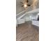 Open-concept living room with staircase and wood-look flooring at 445 Fountainhead Cir # 262, Kissimmee, FL 34741