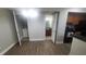 Open living space showing the laundry closet, entry to the bathroom, and the kitchen at 445 Fountainhead Cir # 262, Kissimmee, FL 34741
