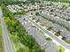 Aerial view highlighting a peaceful neighborhood with tree-lined streets, sidewalks, and a variety of well-kept townhomes at 449 Cruz Bay Cir, Winter Springs, FL 32708