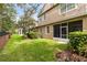 Lush backyard featuring green lawn, shrubs, and a screened-in patio at 449 Cruz Bay Cir, Winter Springs, FL 32708