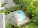 Birds eye view of an inviting neighborhood swimming pool surrounded by lounge chairs, tables, and lush landscaping at 449 Cruz Bay Cir, Winter Springs, FL 32708