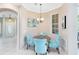 Cozy dining area features a chandelier over a round table with four accent chairs and a sunlit window at 449 Cruz Bay Cir, Winter Springs, FL 32708