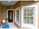 Charming front porch featuring an oval-windowed door, a decorative bicycle, and an inviting welcome mat at 449 Cruz Bay Cir, Winter Springs, FL 32708