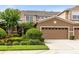 Inviting two-story townhome with a neatly maintained lawn, complemented by a two-car garage and neutral color palette at 449 Cruz Bay Cir, Winter Springs, FL 32708