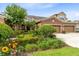 Charming home with lush landscaping, a well-manicured lawn, and an attached garage at 449 Cruz Bay Cir, Winter Springs, FL 32708