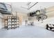 Organized garage with overhead storage, a folding screen, and epoxy flooring at 449 Cruz Bay Cir, Winter Springs, FL 32708