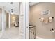 Hallway showcasing the home's neutral color scheme, tile flooring, and a glimpse of a half bath at 449 Cruz Bay Cir, Winter Springs, FL 32708