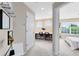 Hallway leading to a bedroom and office/study area with carpet flooring at 449 Cruz Bay Cir, Winter Springs, FL 32708