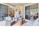 Relaxing screened patio with comfortable seating and view into the home at 449 Cruz Bay Cir, Winter Springs, FL 32708