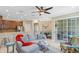 Bright living room featuring tile flooring, a ceiling fan, and sliding glass doors at 449 Cruz Bay Cir, Winter Springs, FL 32708