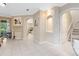 Open-concept living room with tile flooring, archways, neutral colors, and a staircase visible in the background at 449 Cruz Bay Cir, Winter Springs, FL 32708