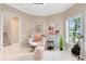 Cozy sitting area with a stylish papasan chair, neutral decor, and natural light from a nearby window at 449 Cruz Bay Cir, Winter Springs, FL 32708