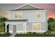 Charming two-story home with light gray siding, a covered entry, and well-maintained landscaping at 5045 Starling Bird Ln, St Cloud, FL 34771