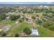 Expansive aerial view of a spacious property featuring lush greenery and multiple structures at 516 Petes Ln, Davenport, FL 33837
