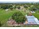Aerial view of the property including home, buildings, grass, trees and open fields at 516 Petes Ln, Davenport, FL 33837