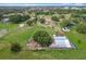 A sprawling property showcased from above, highlighting its rural charm and diverse buildings at 516 Petes Ln, Davenport, FL 33837