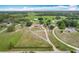 Overhead view of a home featuring a long driveway and a sprawling green lawn surrounded by trees at 516 Petes Ln, Davenport, FL 33837