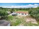 Aerial view of the property including home, buildings, grass, trees and open fields at 516 Petes Ln, Davenport, FL 33837