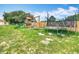 Backyard with green grass, playground with slide and playhouse and a trampoline at 516 Petes Ln, Davenport, FL 33837
