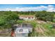 A private backyard featuring a home with an attached patio, complemented by mature trees at 516 Petes Ln, Davenport, FL 33837