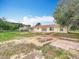 Sprawling backyard with brick patio and well-maintained lawn and back exterior of house at 516 Petes Ln, Davenport, FL 33837