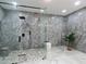 Beautiful bathroom with glass enclosed shower and marble tiling features a sleek modern toilet at 516 Petes Ln, Davenport, FL 33837
