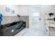 Stylish bathroom featuring a modern tub, sleek vanity with double sinks, and elegant gray accents at 516 Petes Ln, Davenport, FL 33837