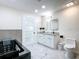 Spa-like bathroom with a contemporary tub, double vanity, sleek fixtures, and stylish marble flooring at 516 Petes Ln, Davenport, FL 33837