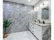 Modern bathroom features marble tile, a double sink vanity with granite counters, and LED lighting at 516 Petes Ln, Davenport, FL 33837