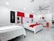 Expansive bedroom featuring two beds, elegant white furniture, and sleek flooring at 516 Petes Ln, Davenport, FL 33837