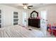 Bright bedroom featuring an elegant dresser, ceiling fan, and modern doors for ample natural light at 516 Petes Ln, Davenport, FL 33837