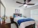 Cozy bedroom with a ceiling fan, comfortable bed, and a dresser for ample storage at 516 Petes Ln, Davenport, FL 33837