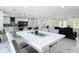 Open floor plan showcasing the dining room, kitchen, and living room with modern finishes at 516 Petes Ln, Davenport, FL 33837