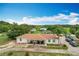 A charming home with a covered porch, complemented by a well-manicured lawn and mature palm trees at 516 Petes Ln, Davenport, FL 33837
