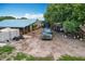 Exterior shot of property with multiple buildings and vehicles and free range chickens at 516 Petes Ln, Davenport, FL 33837