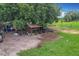 Exterior shot of property with multiple buildings and vehicles and free range chickens at 516 Petes Ln, Davenport, FL 33837