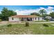 Lovely home featuring a well-kept lawn and inviting front porch with seating area at 516 Petes Ln, Davenport, FL 33837