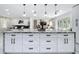 Open-concept kitchen with a large island with marbled countertop and modern pendant lighting at 516 Petes Ln, Davenport, FL 33837