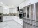 Elegant kitchen featuring stainless steel appliances, custom cabinets, and marble countertops at 516 Petes Ln, Davenport, FL 33837