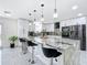 Modern kitchen with granite counters, stainless appliances, and island with pendant lighting is great for entertaining at 516 Petes Ln, Davenport, FL 33837