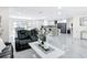 Open-concept living room and kitchen with marble floors and sleek, modern design offers style and functionality at 516 Petes Ln, Davenport, FL 33837