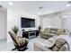 Inviting living room featuring a comfortable sectional sofa, rocking chair, and modern entertainment center at 516 Petes Ln, Davenport, FL 33837