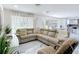 Open living room showcasing large windows, and access to the kitchen and backyard at 516 Petes Ln, Davenport, FL 33837