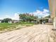 Wood-look tiled patio with view of the house's yard and an outdoor entertaining area at 516 Petes Ln, Davenport, FL 33837