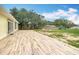Wood-look tiled patio and back yard can be accessed through glass french doors from inside the home at 516 Petes Ln, Davenport, FL 33837