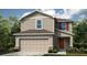 Charming two-story home featuring a neutral color palette and an attached two car garage at 661 Teviot Rd, Haines City, FL 33844