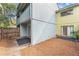 View of the backyard with a wood fence, exterior door and tropical foliage at 7475 Canford Ct # 21, Winter Park, FL 32792