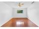 This bedroom includes hardwood floors, a ceiling fan and a view of the outside at 7475 Canford Ct # 21, Winter Park, FL 32792